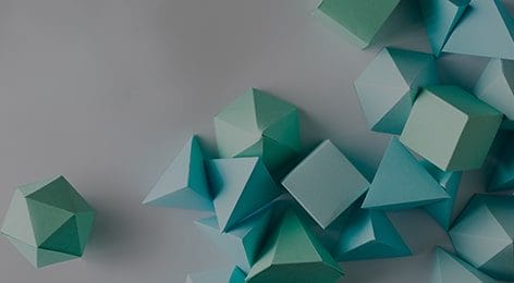 a bunch of blue geometric shapes made out of paper on a table .